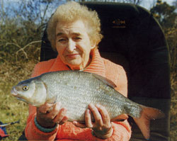 10 Pin Award winner Eileen Coulter with one of her trio of roach/bream hybrids from the River Bann in March 2003
